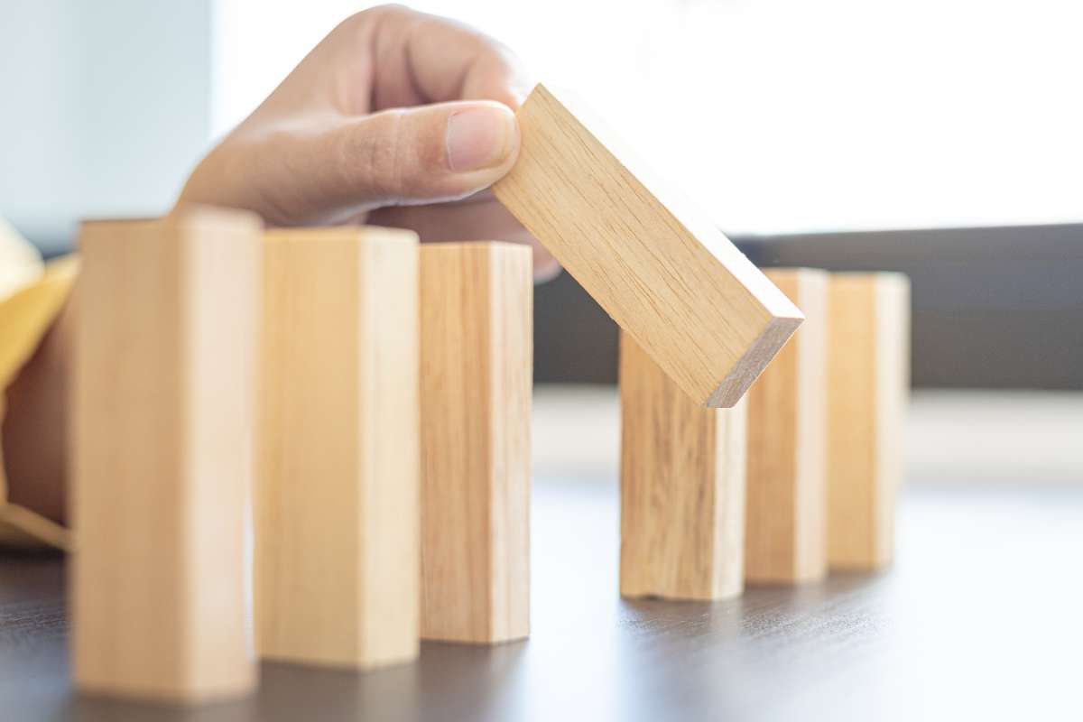 Hand stacking blocks representing the mediation intake process